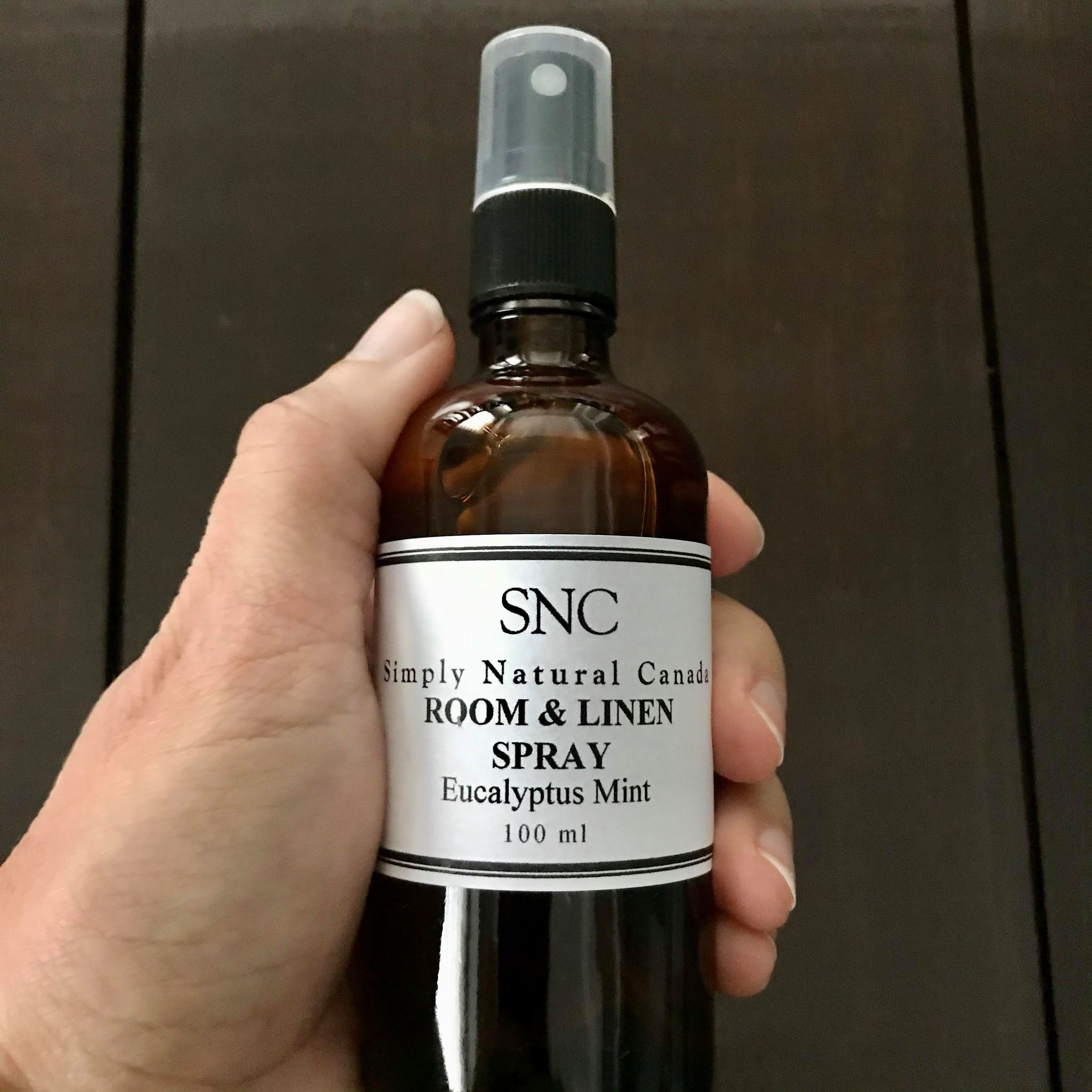 Close-up of the rounded, fragranced linen spray nozzle with a matte white finish and subtle embossed branding detail.