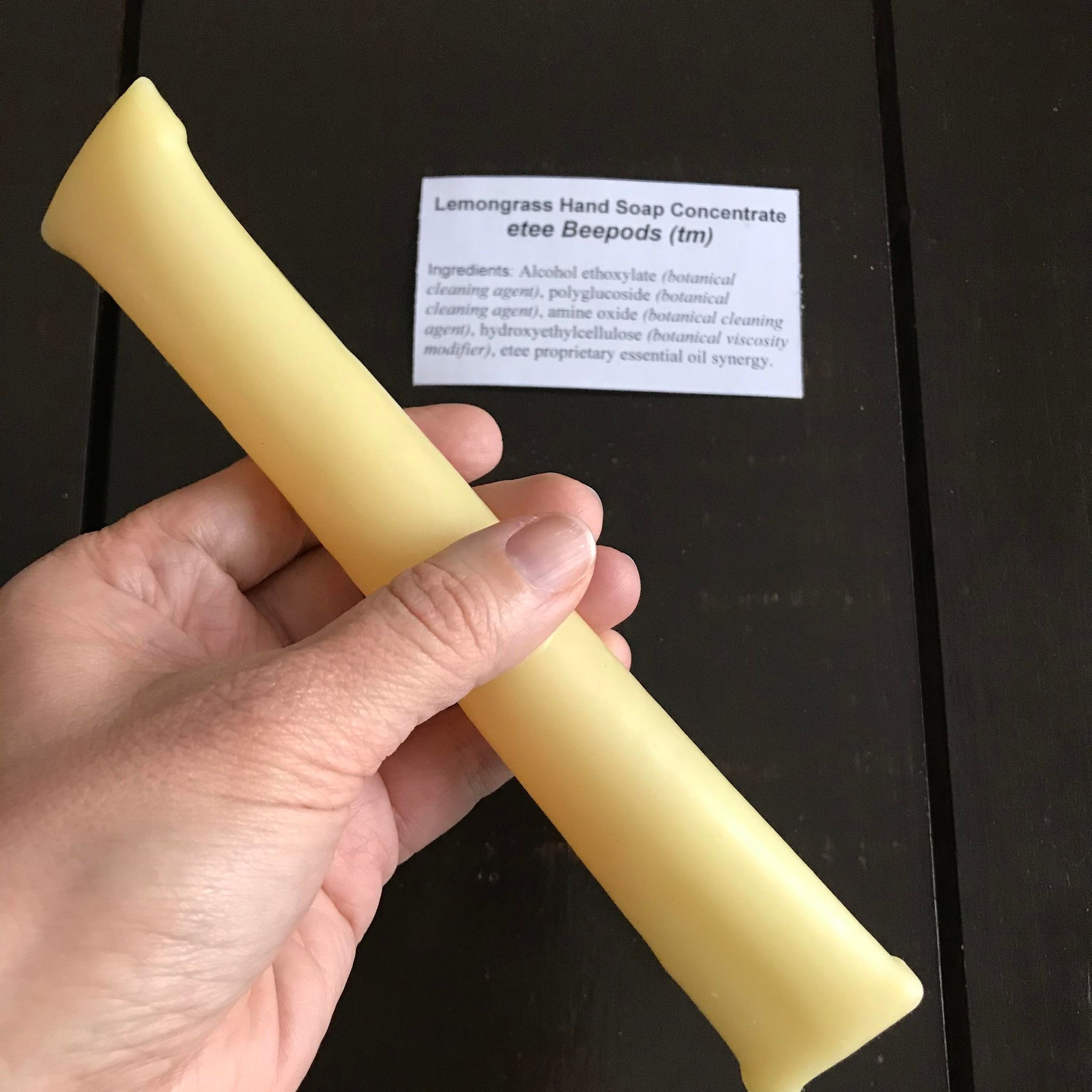 Image 4: Clear view of lemon grass-scented concentrate in transparent pump bottle with textured soap label and silver pump