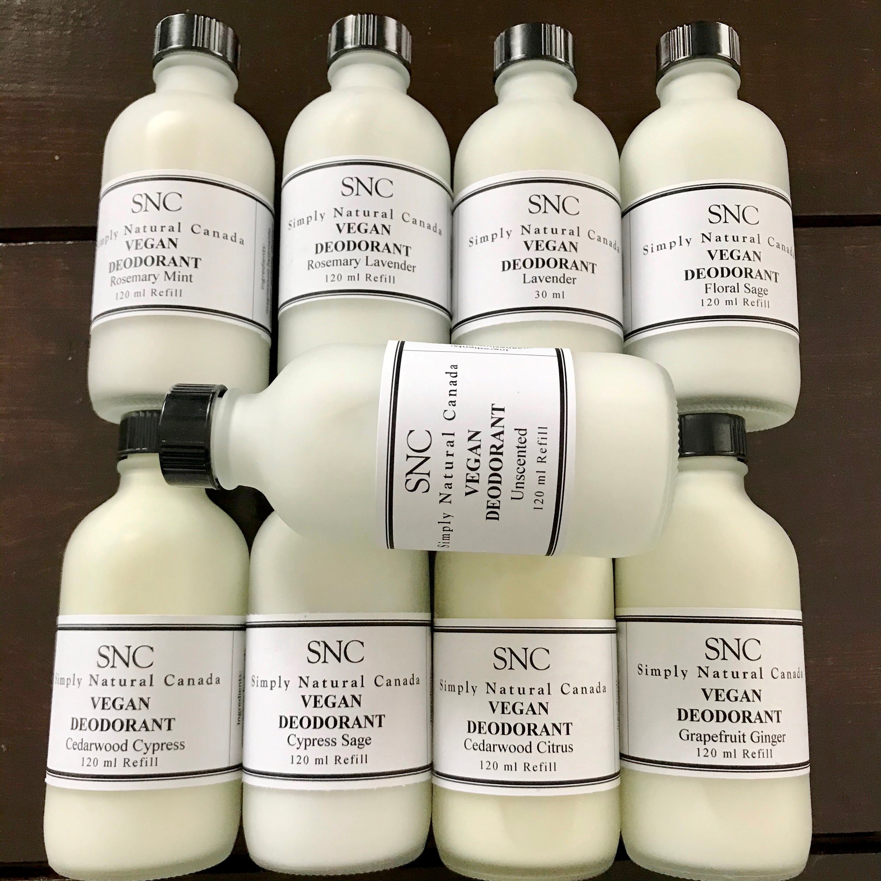 Vegan liquid deodorant refill with clear plastic container, white roller ball applicator, and black screw cap, branded