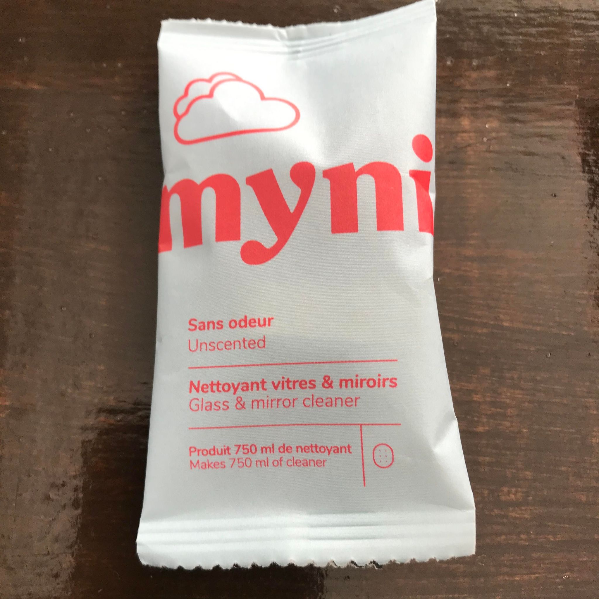 Close-up of Myni Cleaning Tablets showing embossed brand logo and textured surface detail, angled to highlight packaging