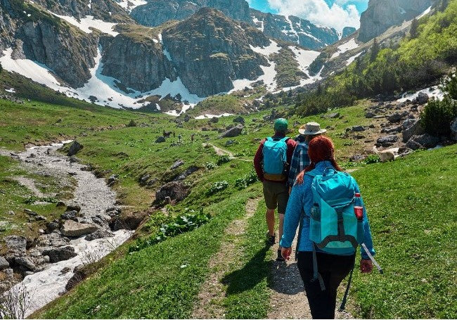 Hiking on mountain trail in Canada staying on path to reduce tick exposure natural tick prevention outdoor safety Canada