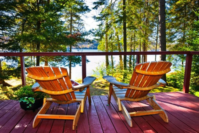 Peaceful cottage deck overlooking lake in Canada showing outdoor space protected from mosquitoes with natural mosquito repellent