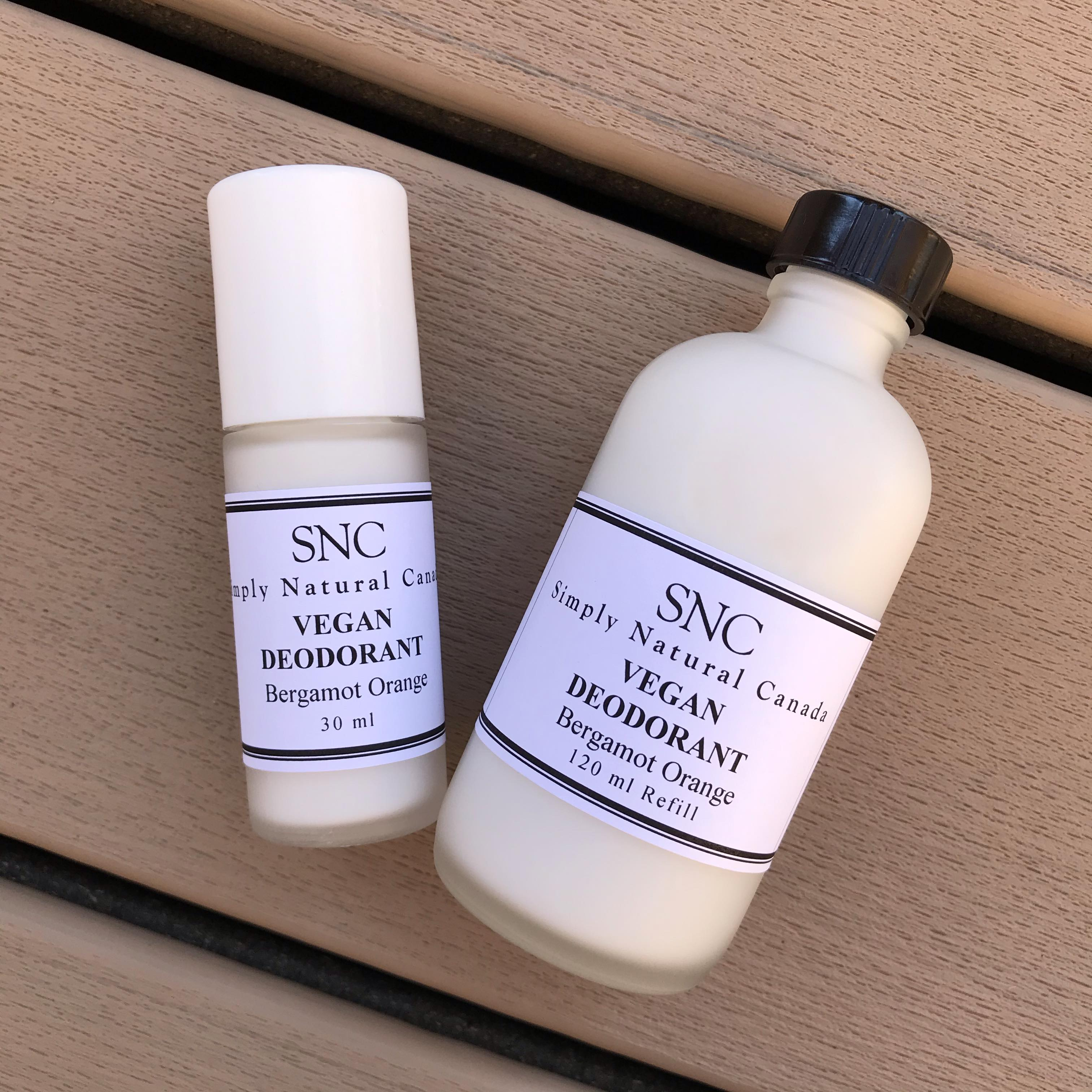 Magnesium based 30 ml deodorant roll on in a glass bottle beside a 120 ml glass refill bottle