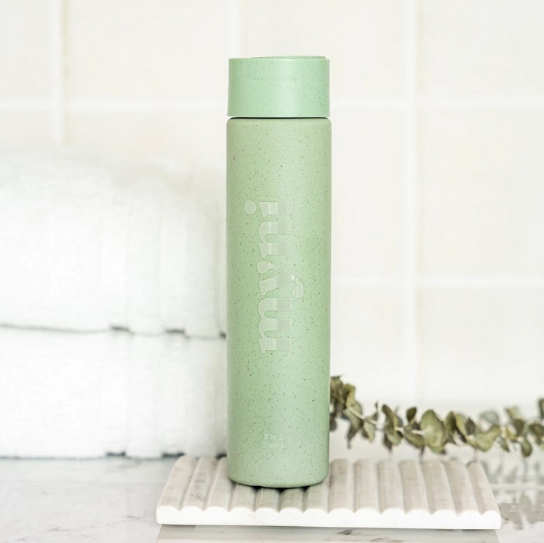 Close-up of Myni 3-in-1 Starter Set bottle neck featuring textured labels and clear product branding in natural light