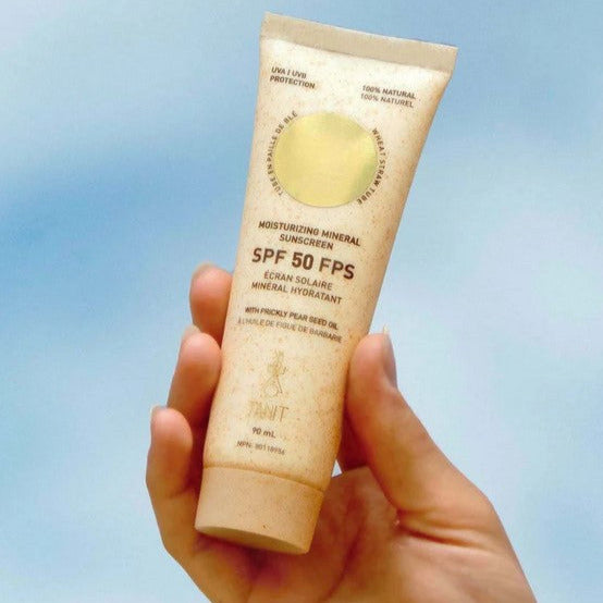 Close-up of Tanit Botanics Mineral Sunscreen tube showing textured formula and fresh citrus scent indicator on label