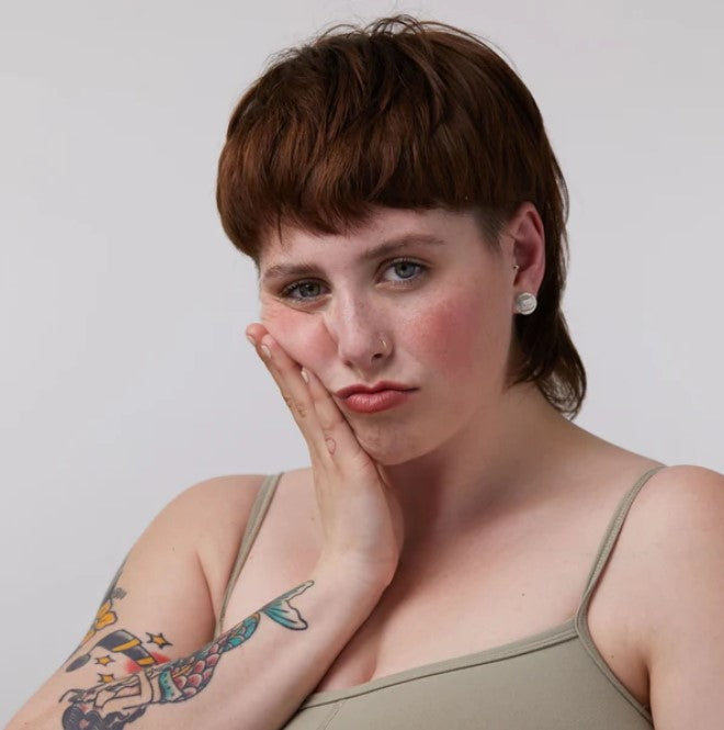 Close-up of the lip and cheek tint applicator with visible warm, creamy texture and natural tint color ready for application.