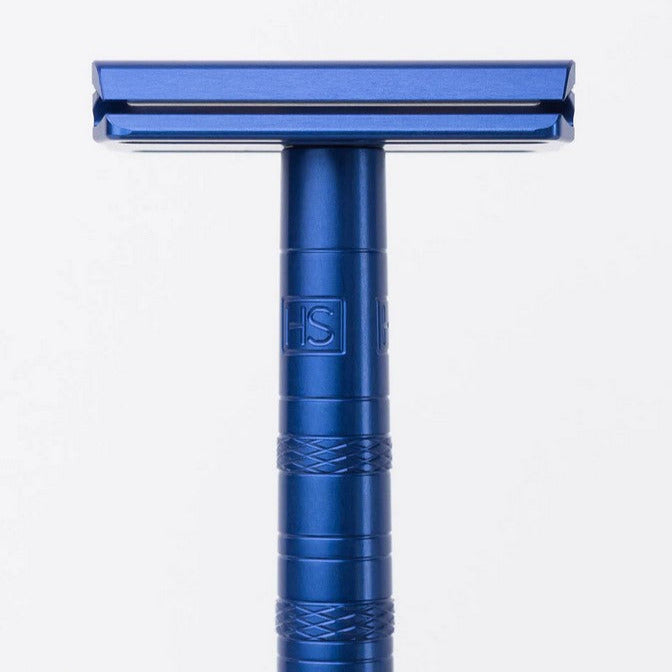 Close-up of the Henson Razor AL13 Steel Blue handle’s textured grip and engraved logo from a bottom-up perspective.