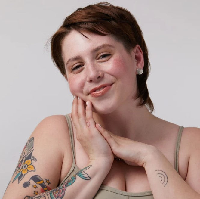 Close-up of the vintage rose tint dispenser showcasing the matte finish and delicate label detail for precise application