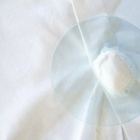 Revolubar laundry detergent tablet packaging close-up, showing eco-friendly label and compact design on countertop.