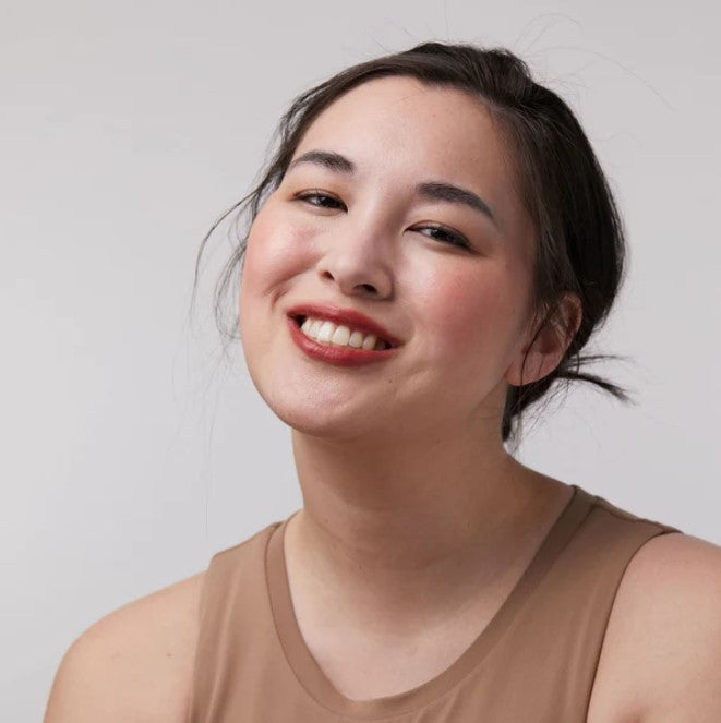 Close-up of the Backcountry Diva Lip and Cheek Tint tube showing natural, amber-colored formula and textured packaging