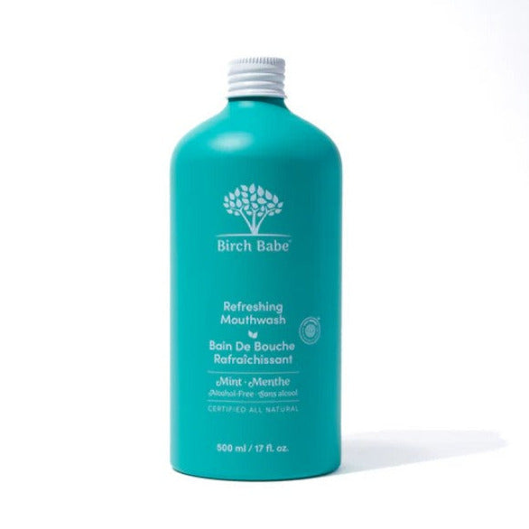 Birch Babe plastic-free mouthwash in clear glass bottle with white screw cap, natural liquid, label with blue and green