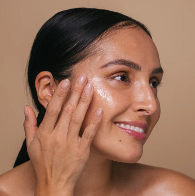 Close-up of the serum’s lightweight, golden gel texture with subtle shimmer, highlighting ease of application on the skin.