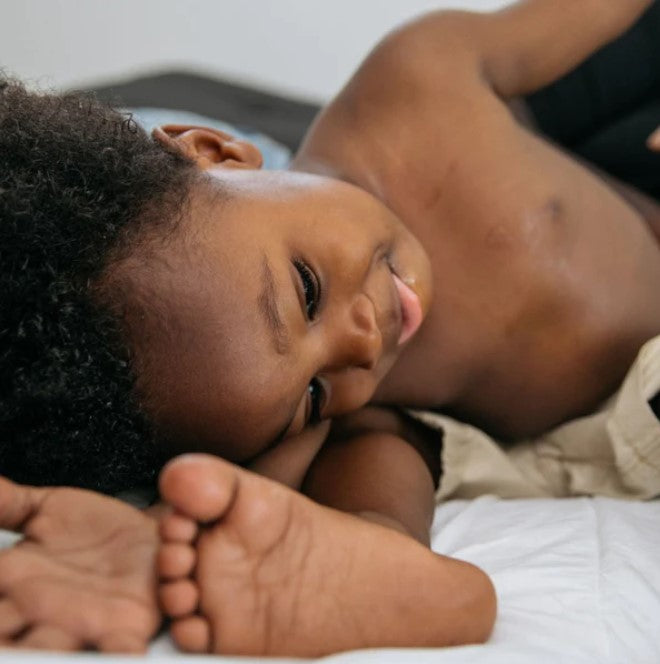 Close-up of Birch Baby Nourishing Lotion bottle neck highlighting natural ingredients and subtle floral scent details atop a