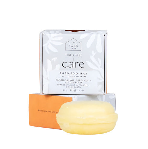 Blood orange, bergamot, and sandalwood scent shampoo bar with textured dark orange and beige layers by The Bare Home