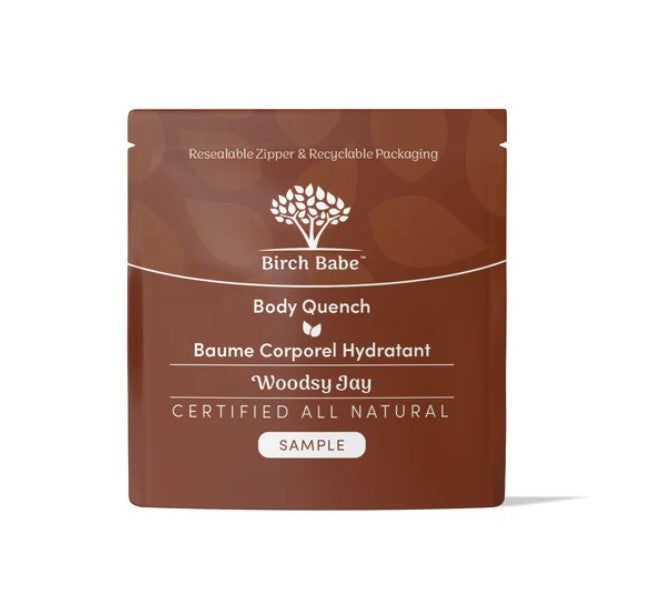 Close-up of Body Quench - Woodsy Jay lotion tube with textured label and earthy woodsy scent notes on a neutral background