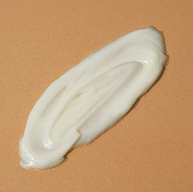 Close-up of the unscented lotion container’s textured cap and clear volume markings, highlighting clean design and precise