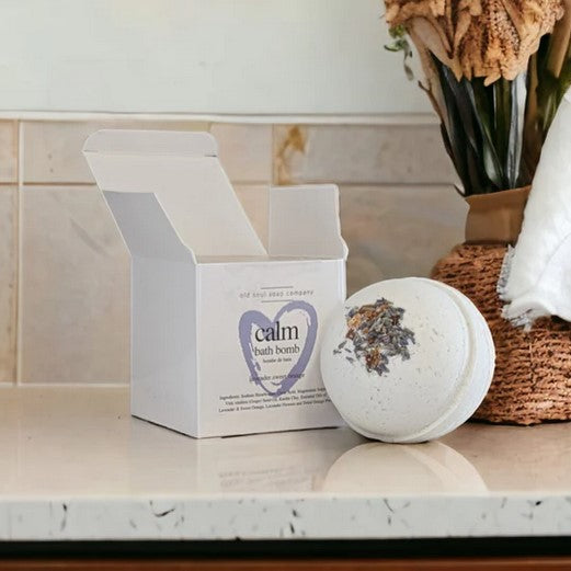 Close-up of the Calm Bath Bomb's textured surface with visible lavender and chamomile dried herbs embedded in a round