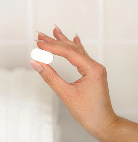 Close-up of Myni Spray Mop Floor Cleaner concentrate label showing dosage instructions and vibrant yellow color design