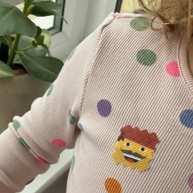 Close-up of NATPAT AllergyPatch sticker's textured surface and vibrant green color showing adhesive edges