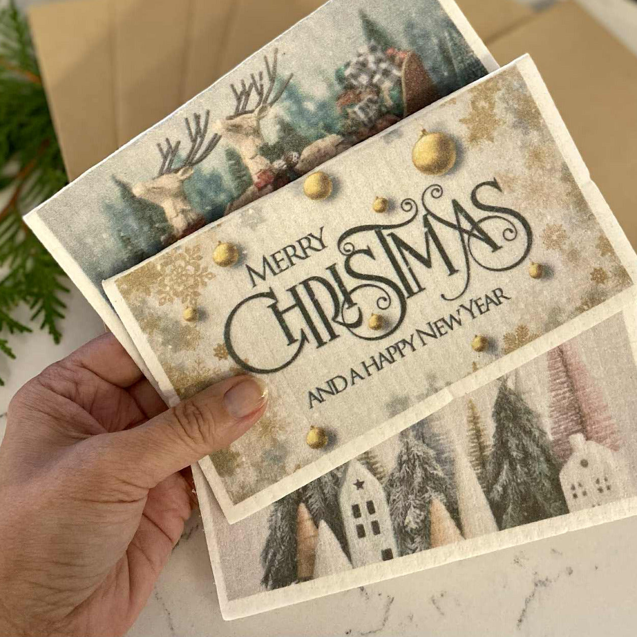 Close-up of the Swedish Dishcloth with festive "Merry Christmas" lettering and detailed red and green holiday pattern