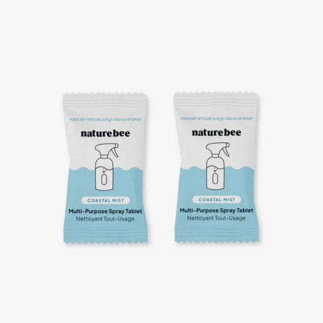 Close-up of Nature Bee Coastal Mist cleaning tablets showing textured surface and distinctive embossed logo on packaging