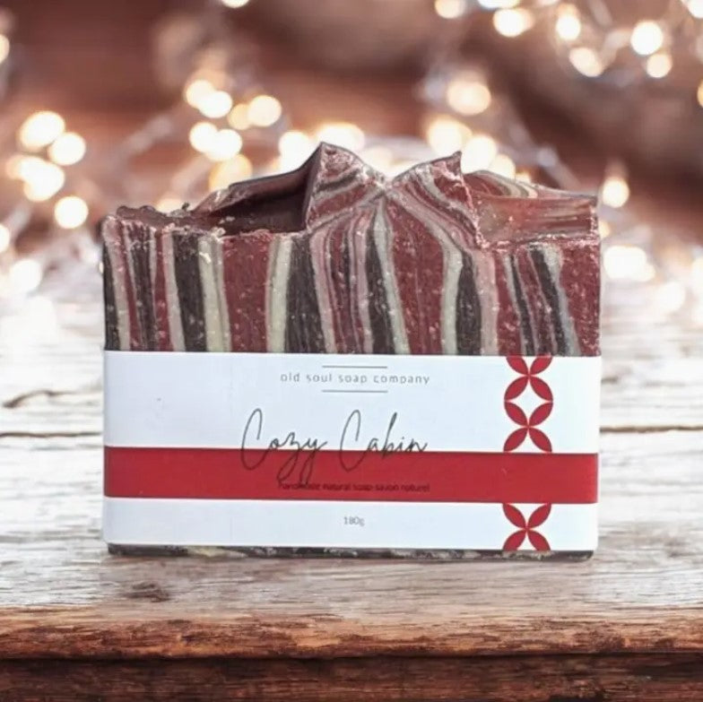 Cozy cabin-inspired artisan goat milk soap bar with creamy beige surface, Old Soul Soap Company branding, vegan and