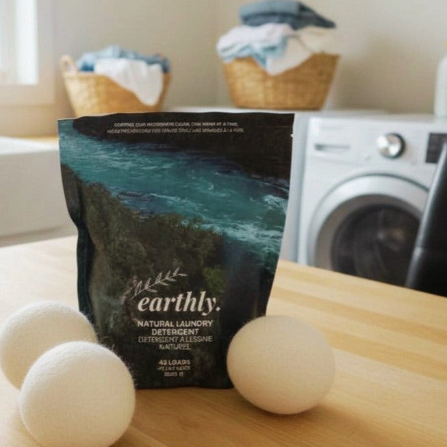 Earthly Canadian made natural laundry detergent powder with wool dryer balls in sustainable laundry room setting