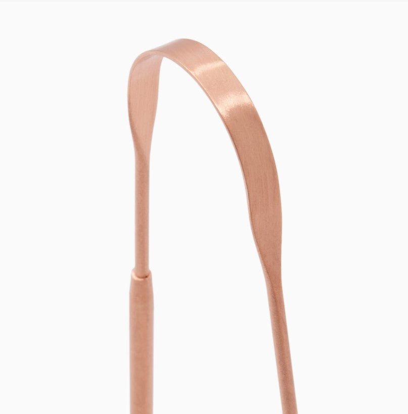 Close-up of pure copper tongue scraper for daily oral care