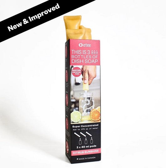 Close-up of clear, flexible plastic dispenser with bright green and white labeling, showing concentrated dish soap details