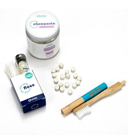 Plastic-free etee dental care kit with bamboo toothbrush, silk dental floss and fluoride Chewpaste tablets on white background