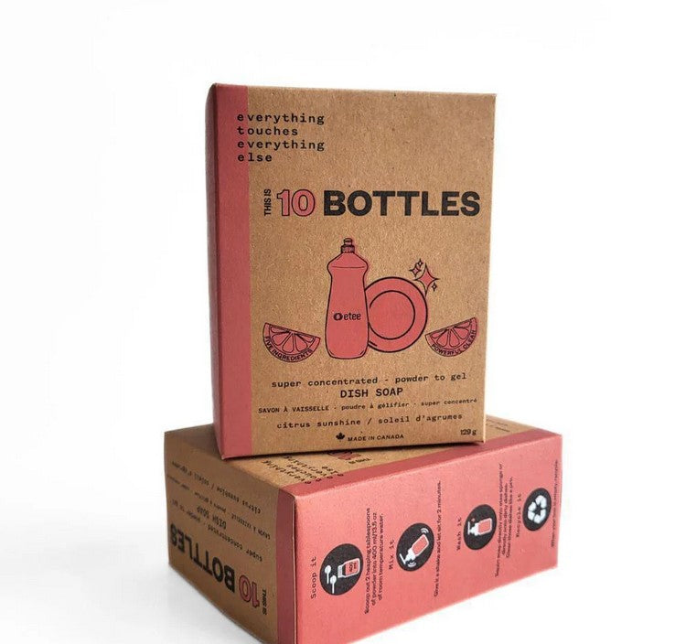 Close-up of the clear, resealable pouch showing bright citrus-flavored gel on a textured white background