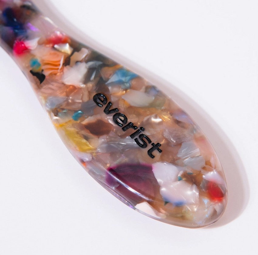 Close-up of the Everist Hair Brush's textured handle showcasing ergonomic grip and intricate detailing for comfortable