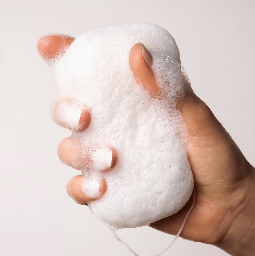 Close-up of the soft, textured surface of the white Konjac sponge highlighting its natural fibers and gentle exfoliating