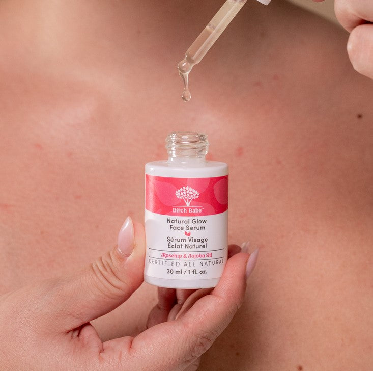 Close-up of the Natural Glow Face Serum bottle showing textured dropper tint and volume details on the label