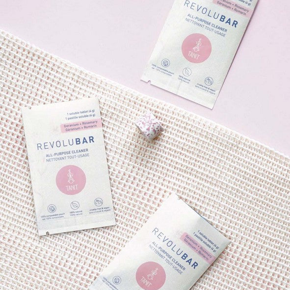 Close-up of Revolubar tablet packaging highlighting the compact, sturdy plastic container with easy-open lid on a white