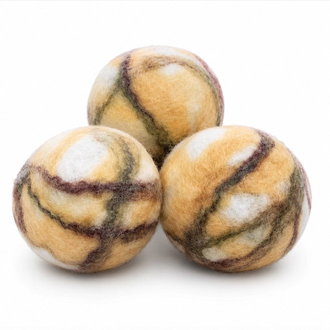 Three cedarwood felted soap juggling balls handmade with Corriedale wool on a white background
