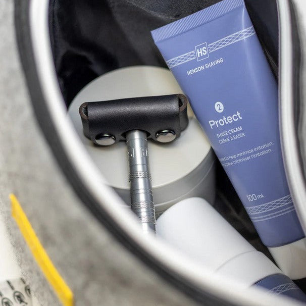 Black Henson Razor Head Cover packed inside travel dopp kit with shaving essentials