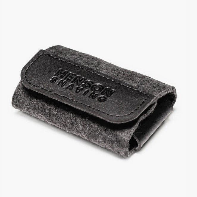 Henson Shaving Razor Travel Case closed in dark grey merino wool and black vegan leather with embossed logo