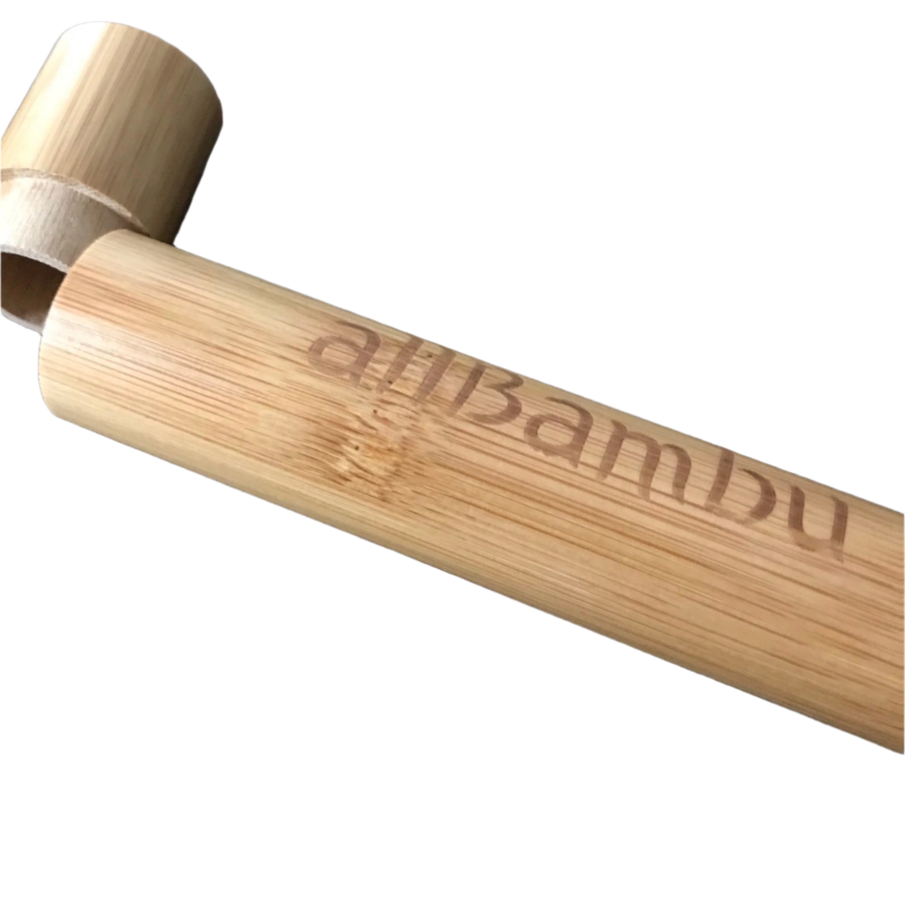 Close-up of allBambu toothbrush accessory with textured bamboo surface and engraved logo detail from an overhead angle