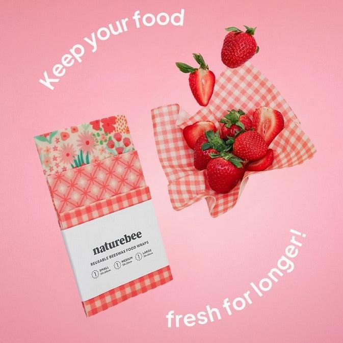 Close-up of the colorful pink beeswax wrap's textured surface featuring organic cotton and vibrant printed design detail.