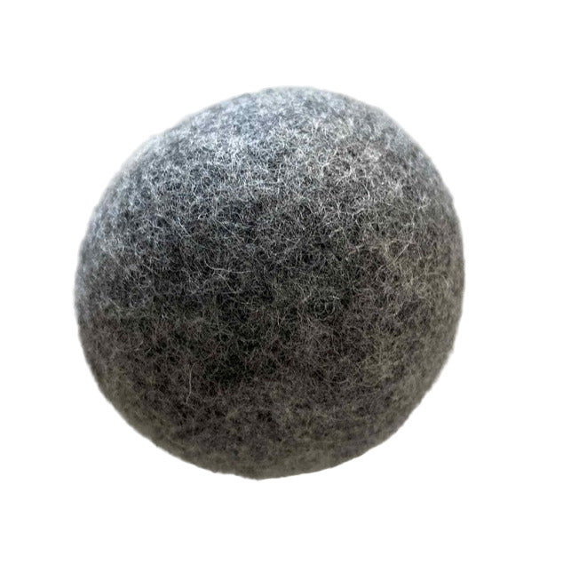 Close-up of Earthly Wool Dryer Balls highlighting their textured, fibrous surface and natural beige color from a slightly