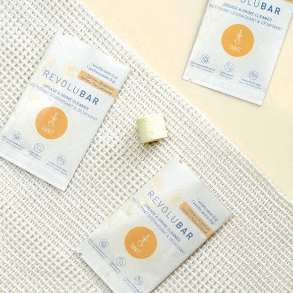 Close-up of the Revolubar cleaner tablet’s textured surface and engraved logo, highlighting its compact, square shape and