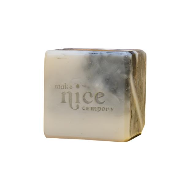 Close-up of the Scrape Solid Dish Soap bar showing textured surface and embedded natural exfoliants, highlighting its