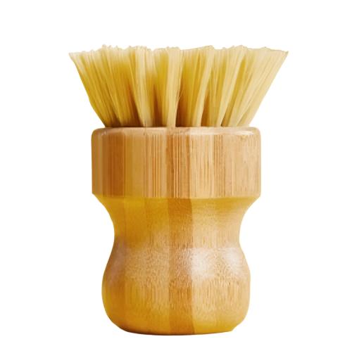 Close-up of the Make Nice Company Scrubber Brush’s textured olive-green bamboo handle and durable natural Tampico fiber