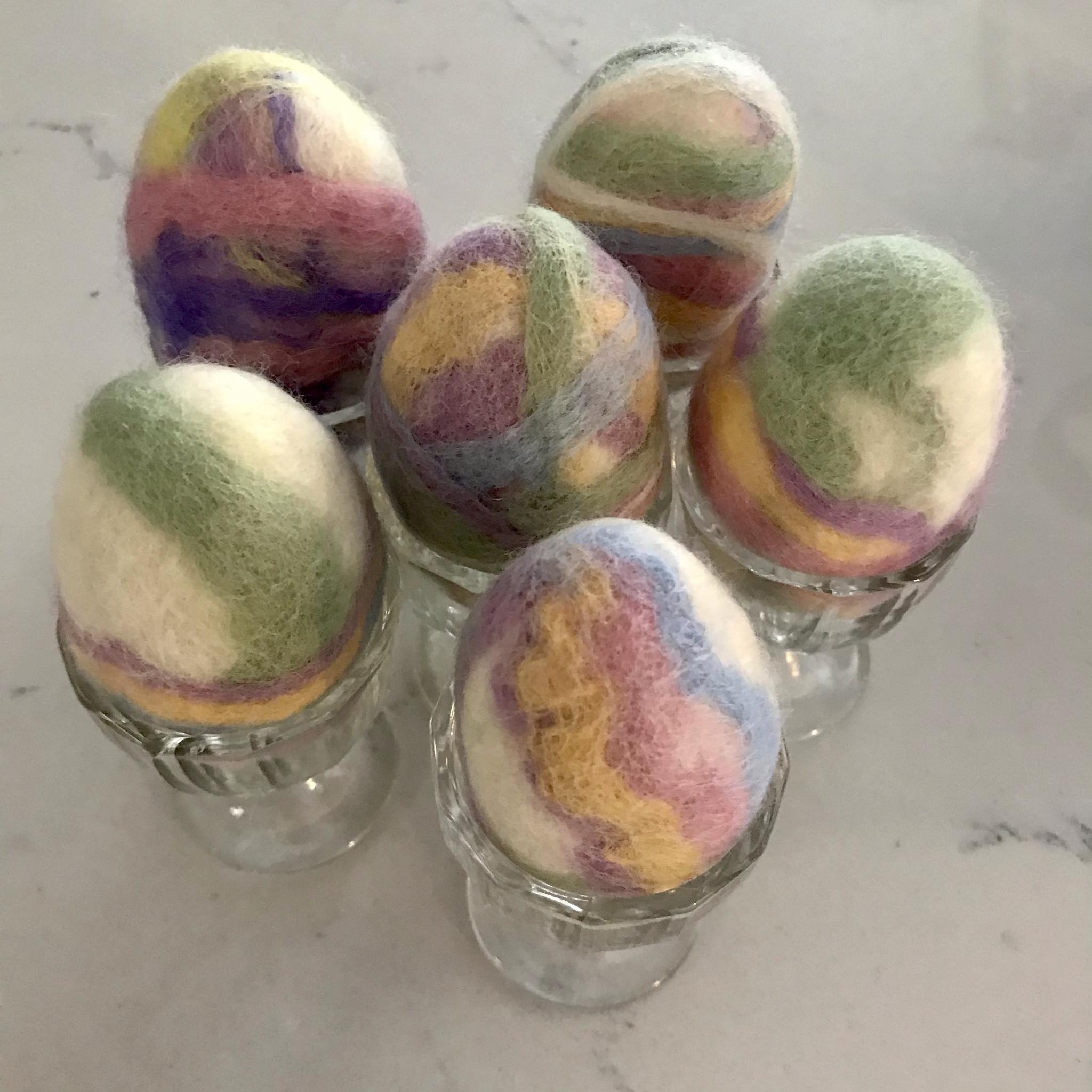 Close-up of the felted soap’s textured surface revealing intricate wool fibers and colorful specks from embedded Easter egg