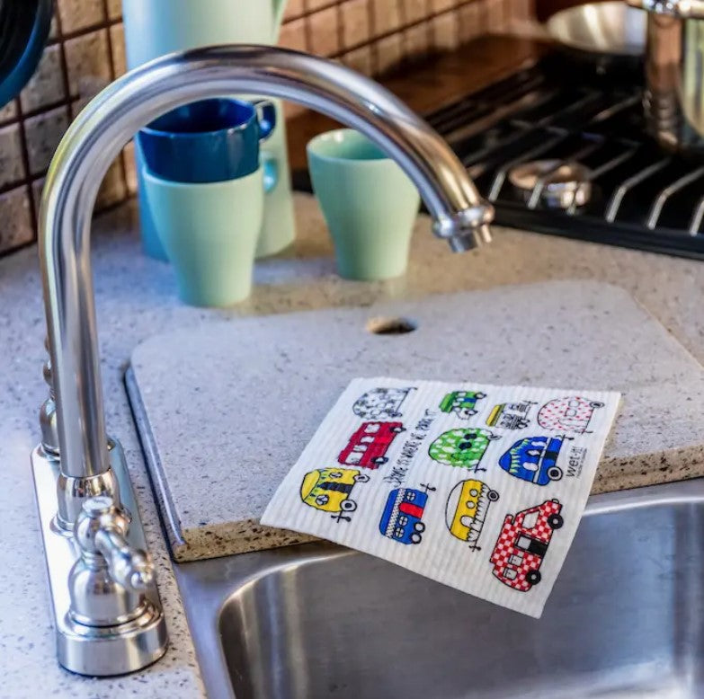 Close-up of the My RV Wet It Cloth’s textured, absorbent green cellulose surface with faint blue printed brand logo