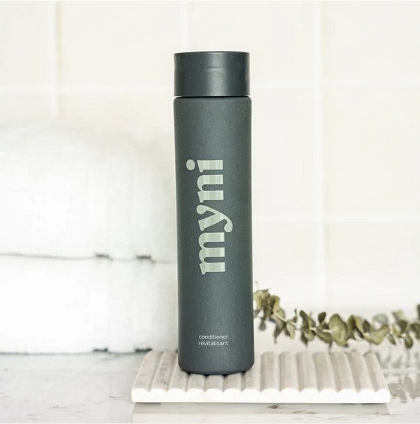 Close-up of the Myni Conditioner Starter Set's textured tube, highlighting its soft feel and easy squeeze application method.