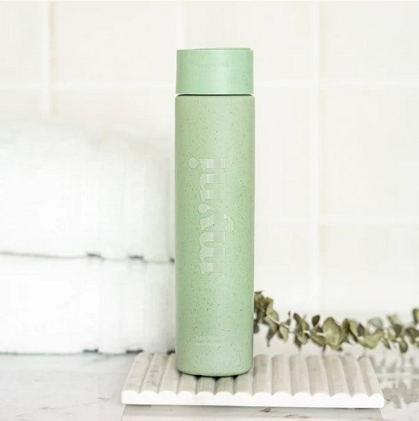 Close-up of Myni Conditioner Starter Set bottle highlighting textured cream formula and subtle floral scent on sleek