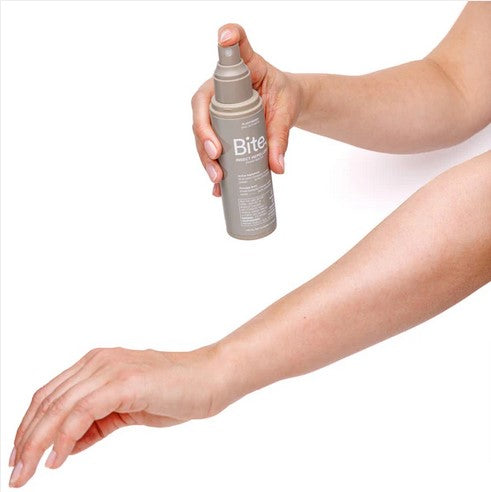 Applying Bite natural insect repellent spray on arm for mosquito and tick protection Health Canada approved bug spray Canada
