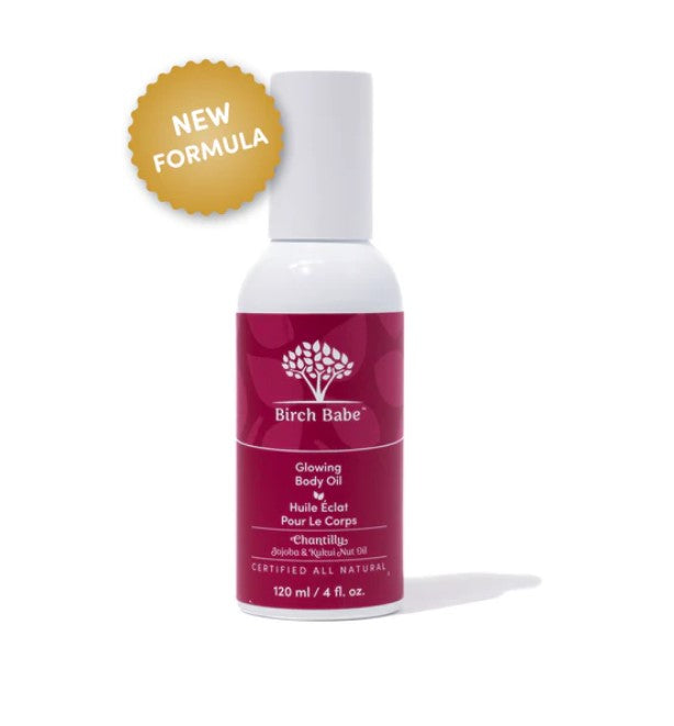 Close-up of glowing amber body oil with textured dropper cap and subtle shimmer on transparent glass bottle lid